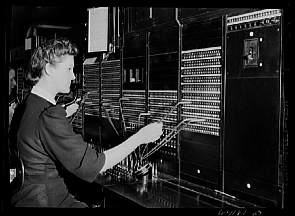 Photo of a telephone switchboard operator.
